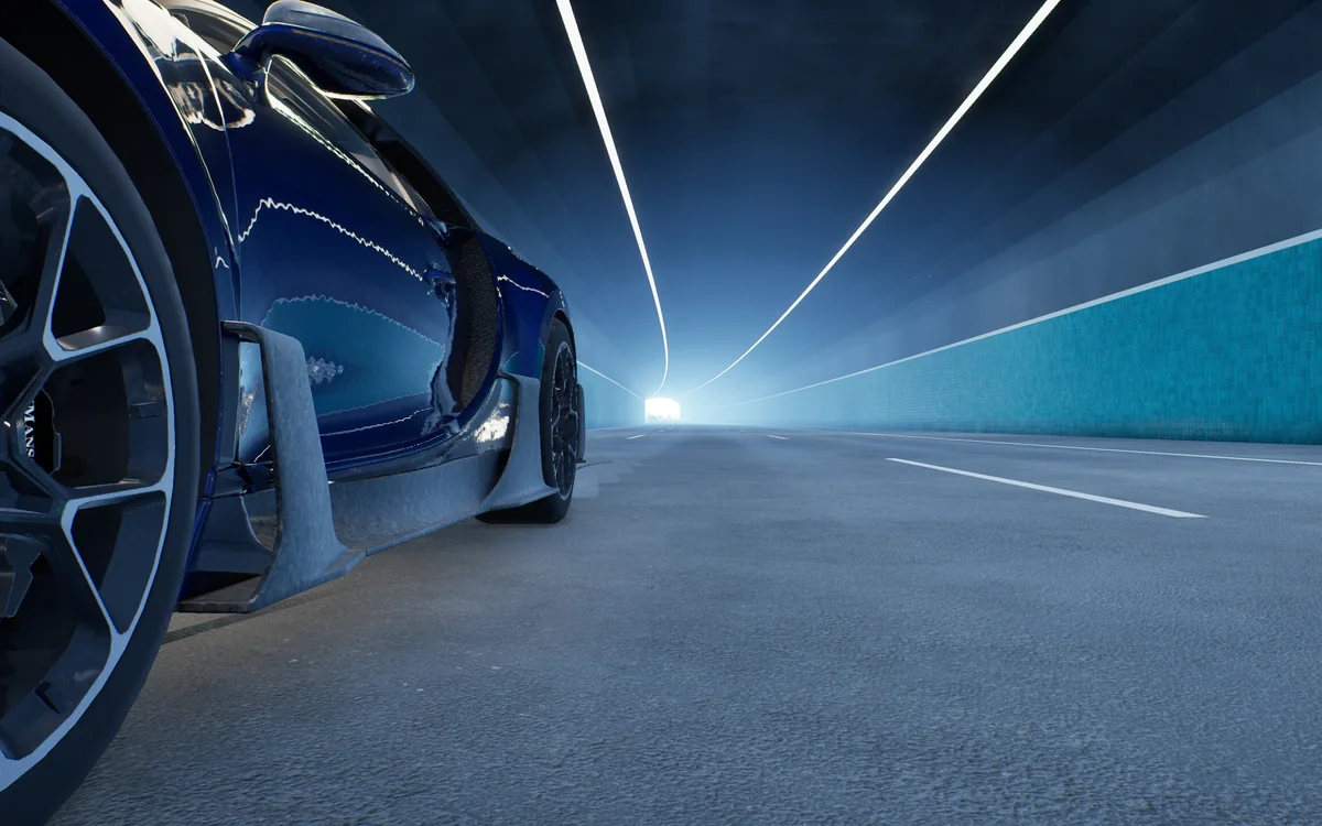 Low beside a front wheel inside a tiled tunnel lit by LED strips